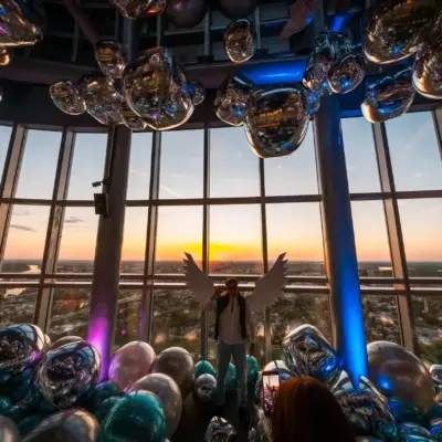A visitor posing with angel wings on the 41st floor of Kula Beograd during the Belgrade 360 Deck VIP opening.